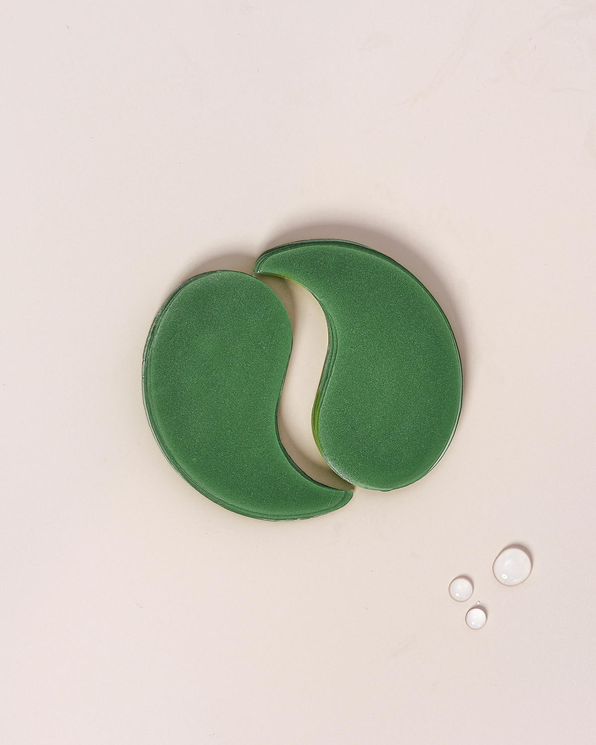 Brightening & Hydrating Eye Masks on a light background, showcasing a pair of green eye patches.