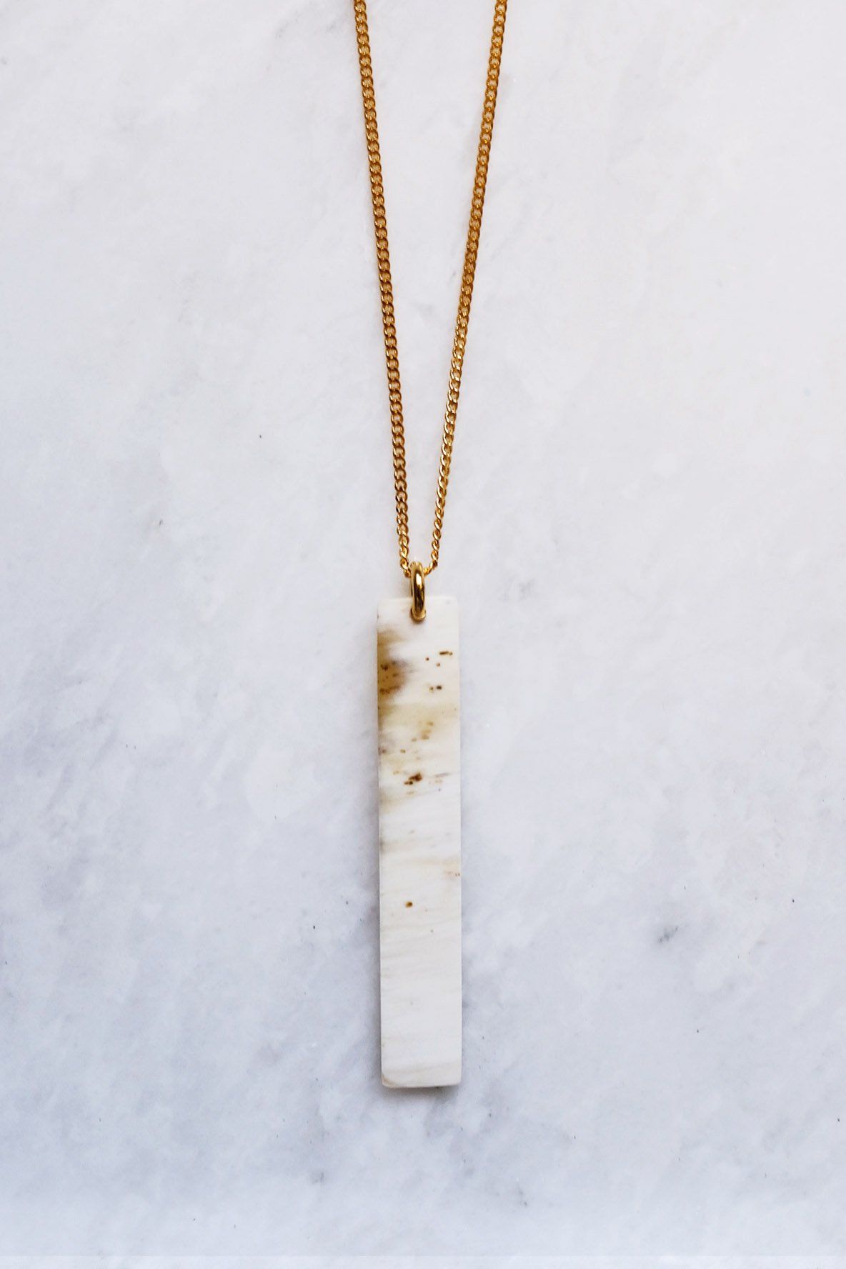 Buffalo Horn Pendant Necklace featuring a minimalist bar silhouette and 16K gold-plated finish