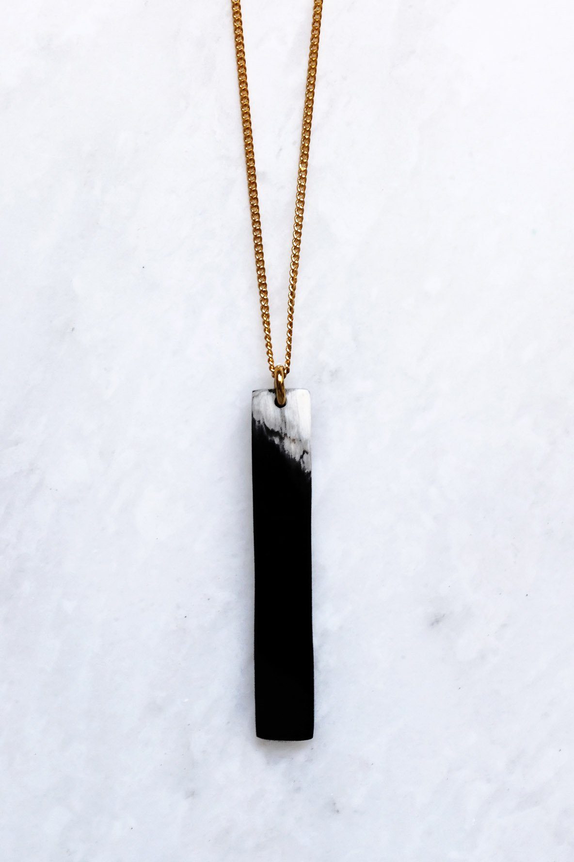 16K Gold-Plated Buffalo Horn Pendant Necklace featuring a minimalist bar silhouette and unique buffalo horn detail.