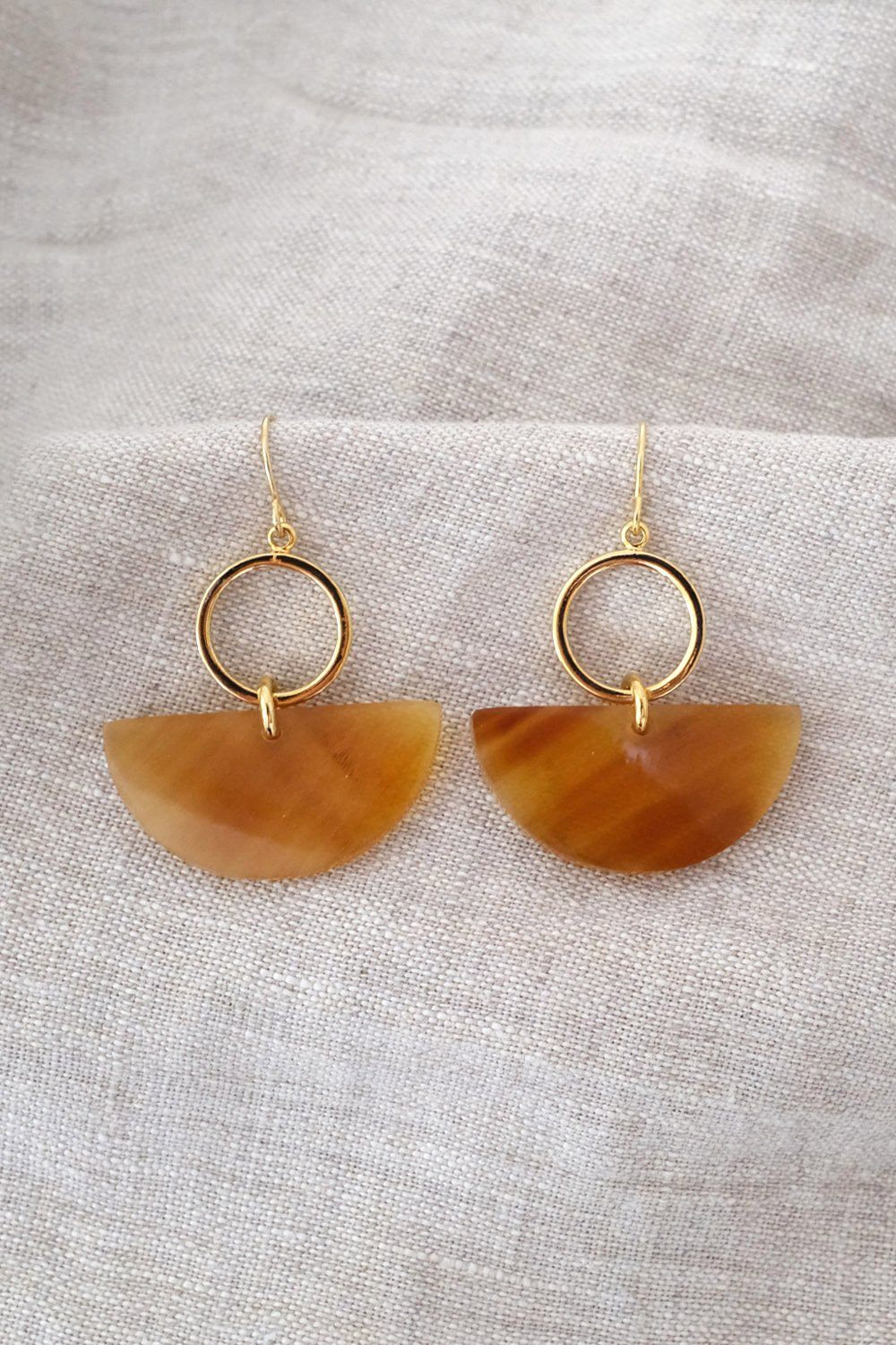 Buffalo Horn Statement Earrings featuring geometric dangle design with golden accents on a neutral background.