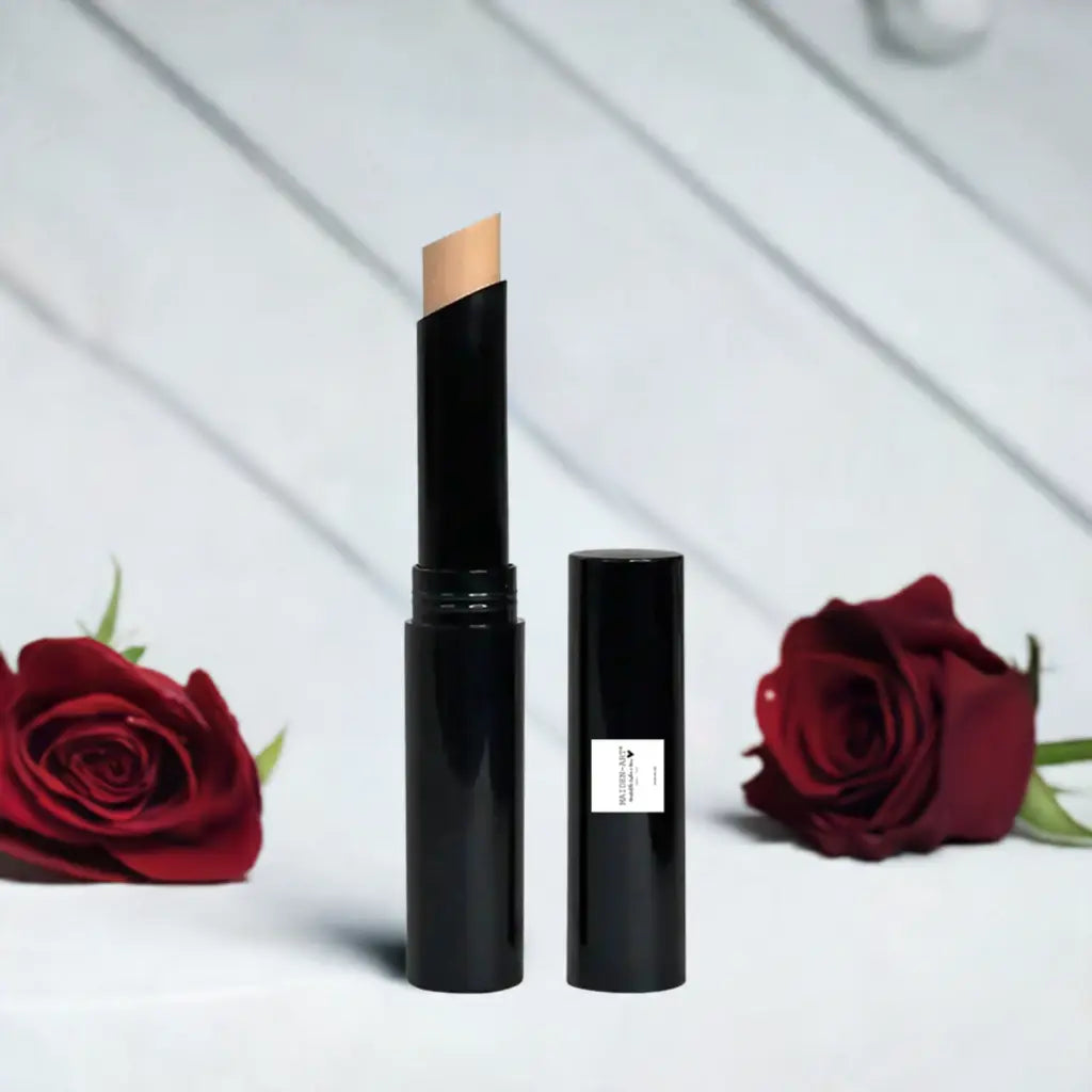 Beige concealer stick placed beside red roses, showing smooth makeup coverage and convenient design.