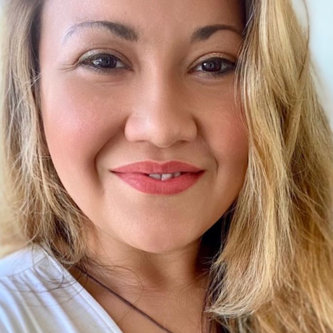 Pop of Color Beauty Kit showcased on a smiling woman with natural makeup and wavy hair.